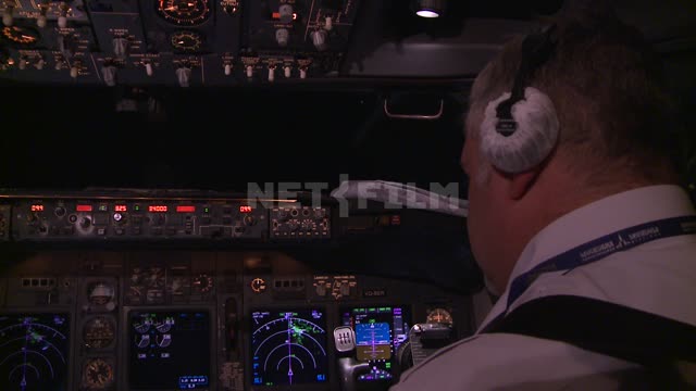 The pilot in the cockpit. Russian North, equipment, scale, airplane, cabin, steering wheel,...