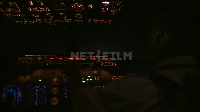 Glowing instrument panel in the cockpit, night flight. Russian North, equipment, scale, airplane,...