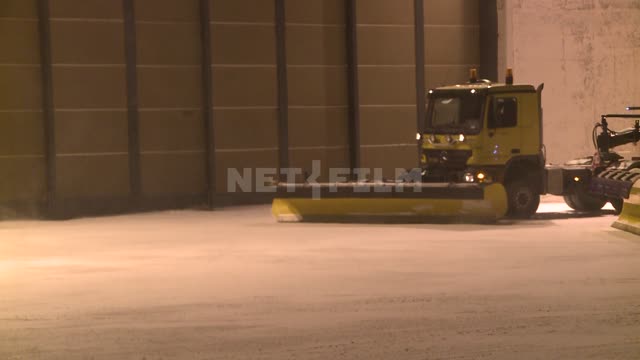 On the background of the airport snowblower-grader with a scoop. Russian North, transport, airport,...