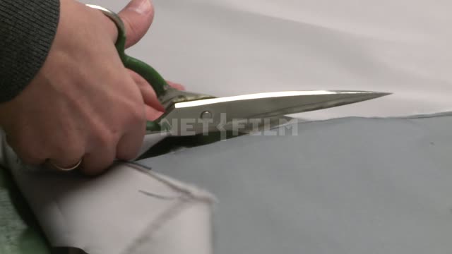 The cutter cuts the fabric. Russian North, seamstress, tailor, fabric, sewing shop, scissors,...