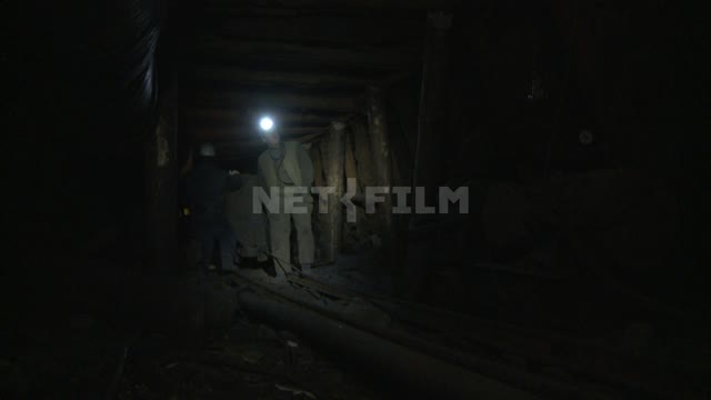 Miners inspect communications of the drift mine. Russian North, miner, mine, mine, helmet, lantern,...