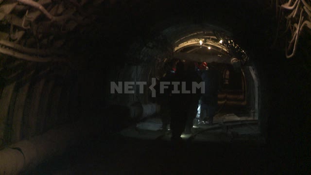 Miners go through the tunnel. Russian North.
Work.
People.
Mine.
Helmet.
Overalls.
Tunnel.
Coal.