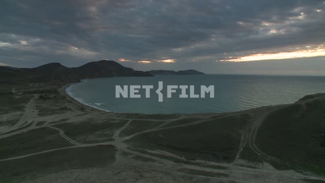 The sea and the mountains. Koktebel, sea, mountains, hills, beach, waves, evening, road.