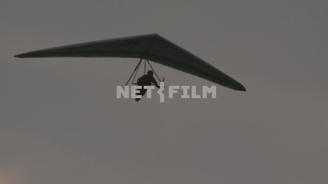 Man flying on a hang glider in the sky. Koktebel, hang gliding, flight.
