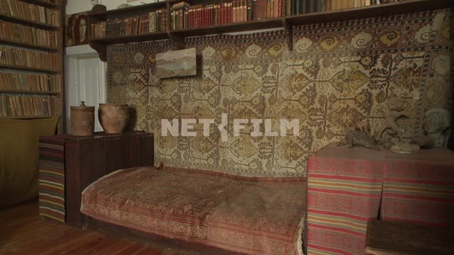 Room with a sofa and shelves of books in the house of Voloshina M. A. Koktebel, sofa, shelves,...