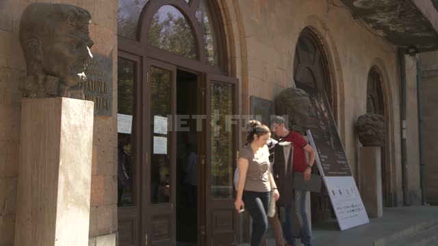 People enter the building of Yerevan Komitas state Conservatory. Architecture.
Building.
The...
