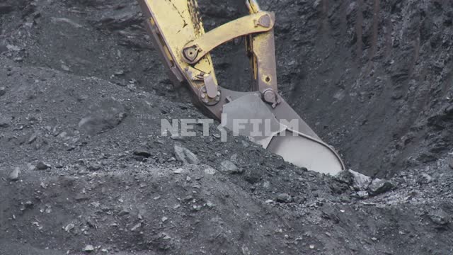 The Komatsu excavator loads the rock into the body of the BelAZ-75170 mining dump truck.
 Bucket,...