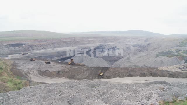 Panorama of the quarry. Quarry, bulldozer, dump truck, coal, slag heap, hill, heap.