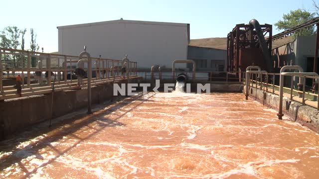 Wastewater flow from the pipe into the tank of the treatment plant. Reservoir, pool, pipe, drain,...