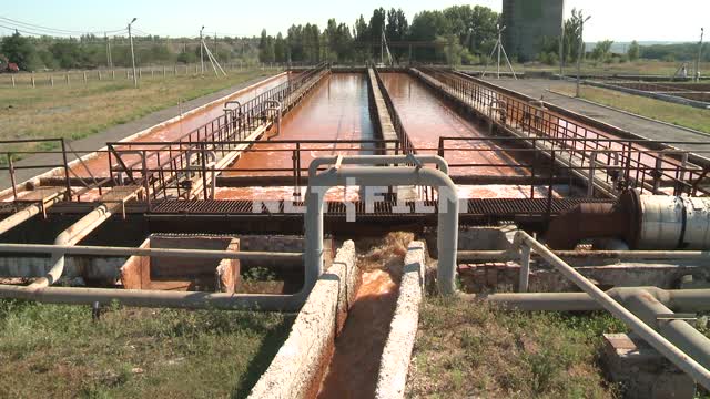 Wastewater flows through the concrete chute into the tanks of the treatment plant. Gutter, drain,...