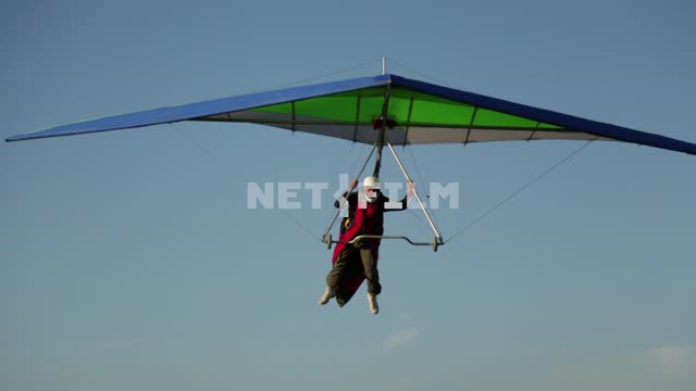 Gliders landing. The hang glider, wing, pilot.