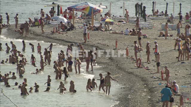Holidaymakers on the beach. Beach, sea, tourists, campers, resort, sea, summer, beach.