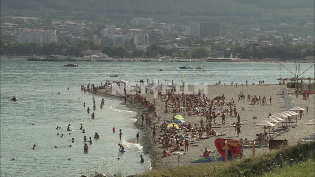 Holidaymakers on the beach. Beach, sea, tourists, campers, resort, sea, summer.